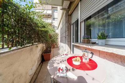 a table with a plate of food on a balcony at St. Peter - Loft at 50m from Metro (up to 4) in Rome
