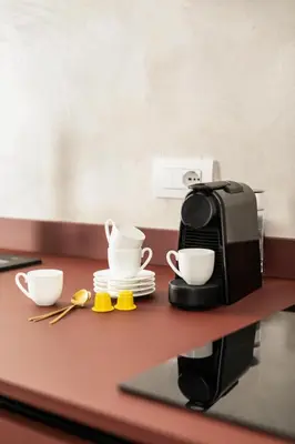 a coffee maker and two cups on a counter at Luxury apartment in Trastevere in Rome