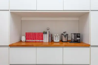 a kitchen counter with appliances on a wooden shelf at Flaminio Historic Charm and Modern Flair in Rome