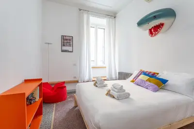 a bedroom with a bed with a shark head on the wall at Flaminio Historic Charm and Modern Flair in Rome