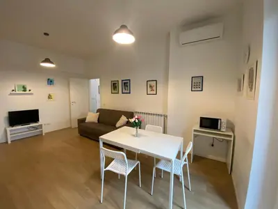 a living room with a table and chairs and a couch at Casa Arcangela by GHOR in Rome
