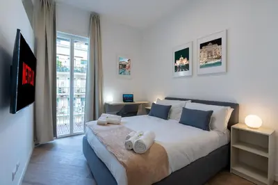 a bedroom with a large bed with towels on it at [15 minutes from the centre] Free Wi-Fi & A/C in Rome