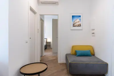a living room with a couch and a table at [15 minutes from the centre] Free Wi-Fi & A/C in Rome