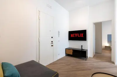 a living room with a tv on a wall at [15 minutes from the centre] Free Wi-Fi & A/C in Rome