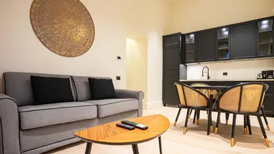a living room with a couch and a table at Pinciana - Veneto - Marilyn House in Rome