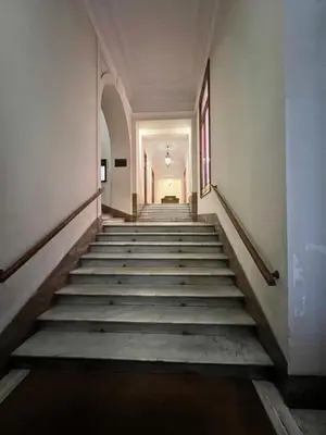 an empty hallway with stairs in an old building at Pinciana - Veneto - Marilyn House in Rome