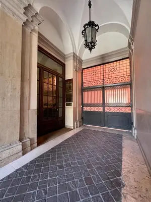an empty hallway of a building with a door and a chandelier at Pinciana - Veneto - Marilyn House in Rome