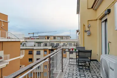 a balcony with two chairs and a view of a city at Design Monteverde Flat in Rome