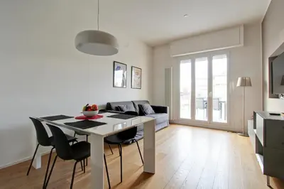 a kitchen and living room with a table and chairs at Design Monteverde Flat in Rome
