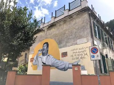 a mural on the side of a building with a man holding a microphone at The Fontana Carlotta at Garbatella in Rome