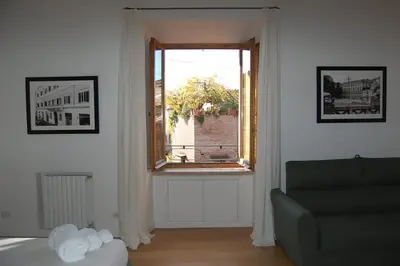 a living room with a window and a couch at Nesty Margana House in Rome
