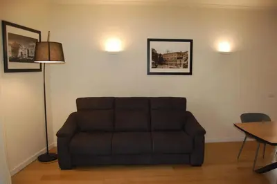 a living room with a couch and a table at Nesty Margana House in Rome