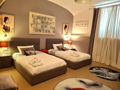 a bedroom with two beds and a room with at la Borghese in Rome