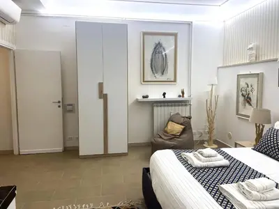 a white bedroom with a bed and a couch at la Borghese in Rome