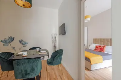 a bedroom with a bed and a table and chairs at Cattaneo monti delizioso e nuovissimo appartamento in Rome