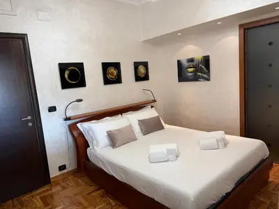 a bedroom with a bed with four pictures on the wall at LUXURY AV in Rome