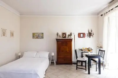 a bedroom with a bed and a table and a desk at Vacanze Romane in Rome