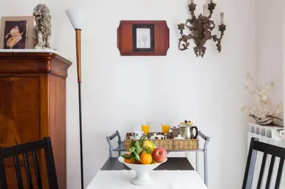 a table with a bowl of fruit on a table at Vacanze Romane in Rome