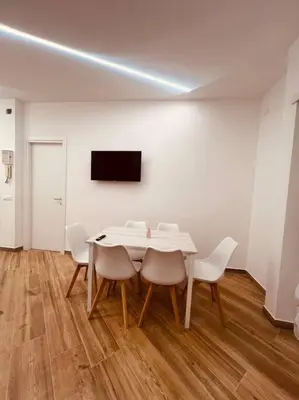 a dining room with a white table and white chairs at 15 Min. Colosseo 1 - Casa di Giò in Rome