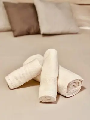 a rolled up towel on top of a bed at 15 Min. Colosseo 1 - Casa di Giò in Rome