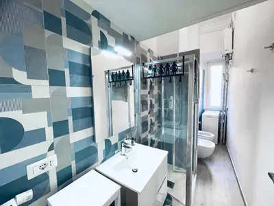 a bathroom with a sink and a shower and a toilet at San Lorenzo 47 Loft in Rome