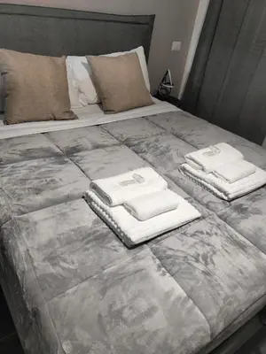a large bed with two towels on top of it at Azzurra Guest House Vaticano in Rome