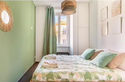 a bedroom with a bed in a room with a window at Azzurra Guest House Vaticano in Rome