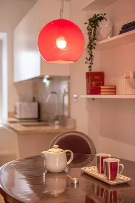 a table with a tea pot and two cups on it at Colosseum Oasis in Rome