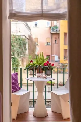 a table with flowers on top of a balcony at Colosseum Oasis in Rome