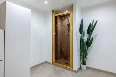 a bathroom with a door with a plant next to it at Lovely studio Apartment - Capocci in Rome