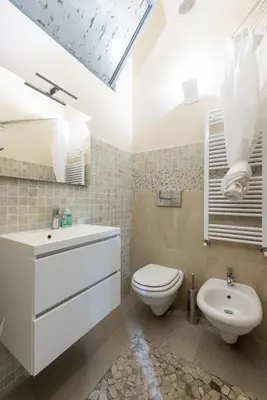 a bathroom with a white sink and a toilet at Lovely studio Apartment - Capocci in Rome