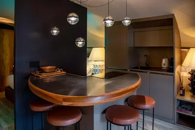 a kitchen with a round counter with stools around it at CadensPlace - Overlooking Piazza Navona by dbalconycollection in Rome
