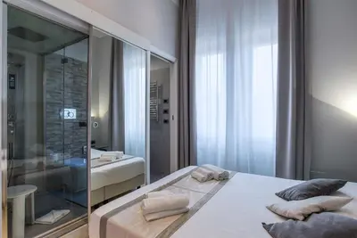 a bathroom with a bed and a sink and a mirror at Pantheon Caesar Relais in Rome