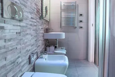 a bathroom with a white toilet and a sink at Pantheon Caesar Relais in Rome