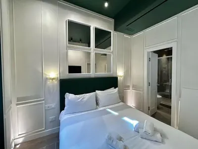 a bedroom with a bed with two towels on it at PRIVATE LUXURY FONTANA DI TREVI in Rome