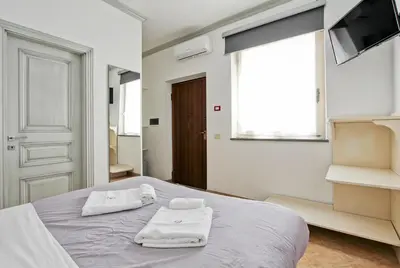 a bedroom with a bed with towels on it at Borgo Dei Centurione in Rome