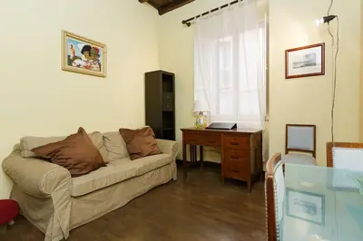 a living room with a couch and a desk at Cozy apartment in Rome