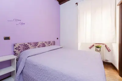 a kitchen with white cabinets and a counter top at Cozy apartment in Rome
