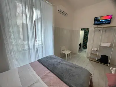 a restaurant with tables and chairs and a kitchen at Hotel Giada Roma in Rome