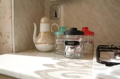 a kitchen counter with bottles and a mortar and pestle on it at Casa di Amici alla Garbatella in Rome