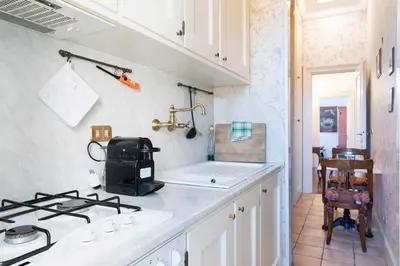 a kitchen with a stove and a counter top at Casa di Amici alla Garbatella in Rome