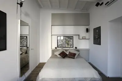 a bedroom with a white bed with two pillows at Antiche Residenze Romane Pantheon in Rome