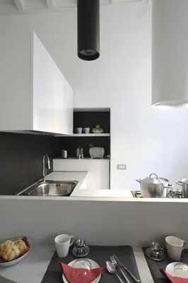 a kitchen with a sink and a bowl of food on a counter at Antiche Residenze Romane Pantheon in Rome