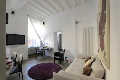 a white living room with a couch and a table at Antiche Residenze Romane Pantheon in Rome