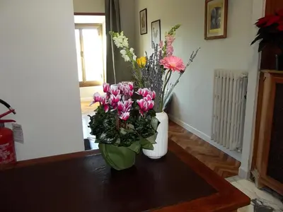 a vase filled with flowers on a table at Bonavista inn in Rome