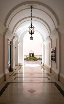 a hallway of a building with a chandelier at Gallery Apartment, Near The Vatican in Rome