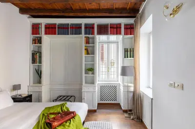 a bedroom with a bed and a book shelf at iFlat Classic And Contemporary Home in Rome