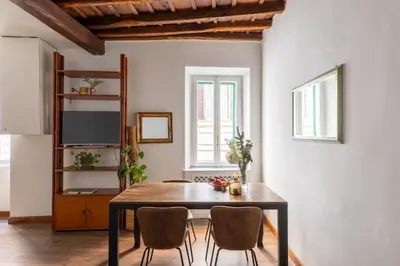 a dining room with a table and two chairs at iFlat Classic And Contemporary Home in Rome