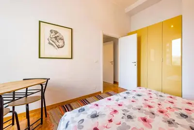 a bedroom with a bed and a desk and a table at La Casa dello Scrittore - Writer's Home in Rome