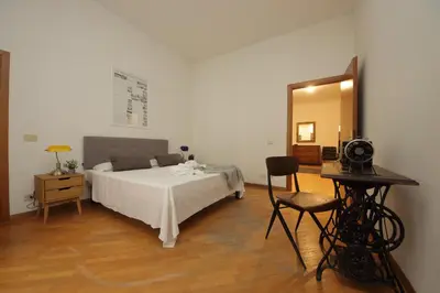 a bedroom with a bed and a mirror and a chair at Giant Borghese Apartment in Rome